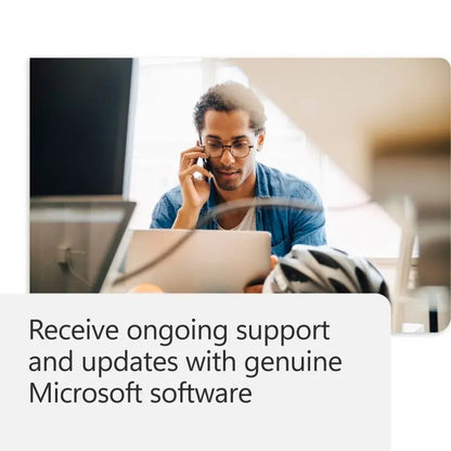 Man on laptop and phone, Microsoft support concept.